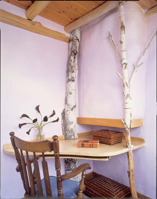 Tucked in a corner nook, Marcia's desk seems to grow from the support of sturdy willow branches.